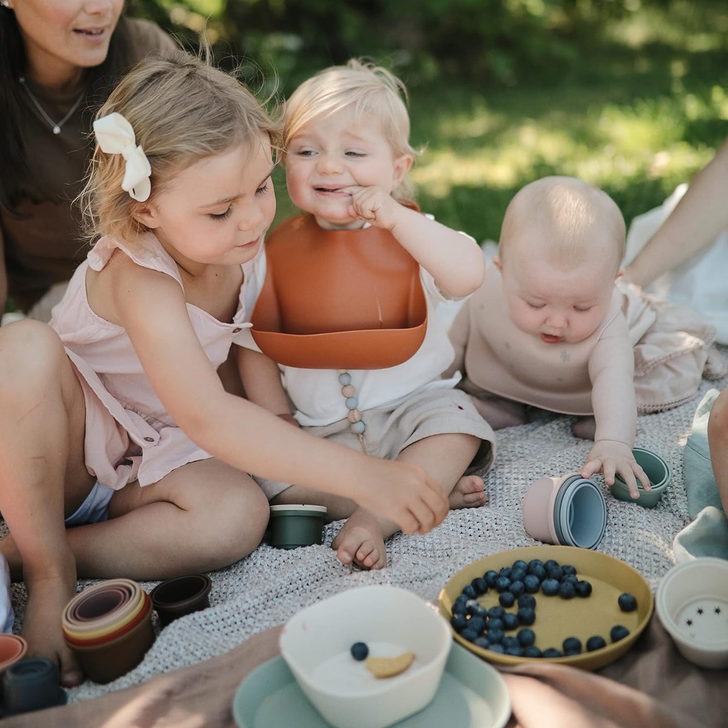 mushie Silicone Baby Bib | Adjustable Fit Waterproof Bibs (Rainbows)